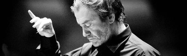 A black and white image of Valery Gergiev conducting