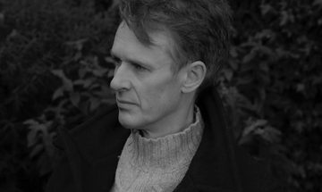 Man with dark hair facing left off camera