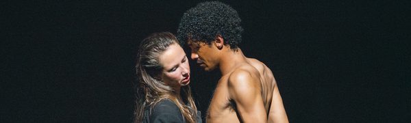 A woman and man stand face to face