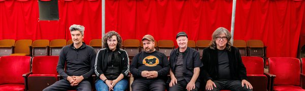 Five people seated and facing camera