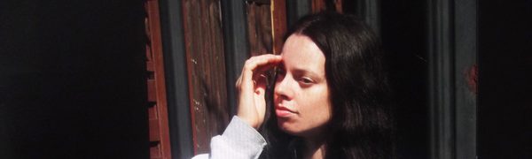 Woman with long dark hair looking off camera
