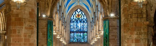 a high ceiling church with stained glassed windows