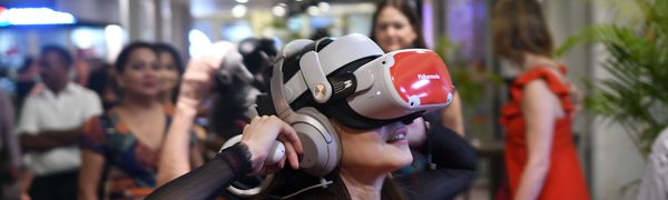 Woman wearing virtual reality headset in crowded room