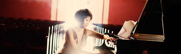 Woman seated playing piano