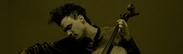 A man focused on playing a cello