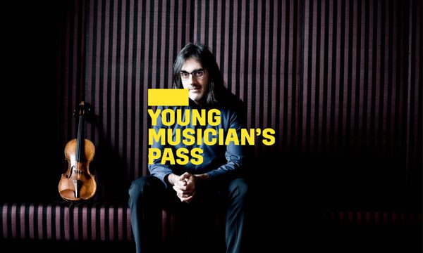 A yellow logo reading Young Musician's Pass overlays a man with long hair and glasses sitting with his hands clasped looking at the viewer. A violin is propped up next to him.