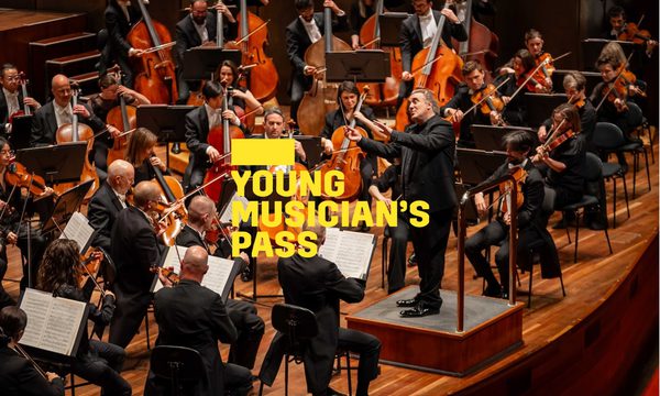 A yellow logo reading Young Musician's Pass overlays an orchestra on stage with the conductor stood before them