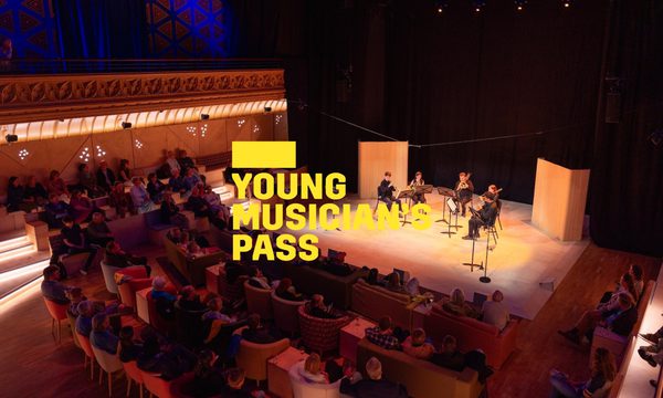A yellow logo reading Young Musician's Pass overlays five musicians playing on a warmly lit stage to an audience.