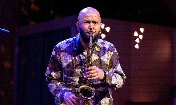 A man plays the saxophone