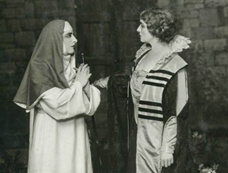 Black and white theatre photo of a nun and a woman in aristocratic clothing