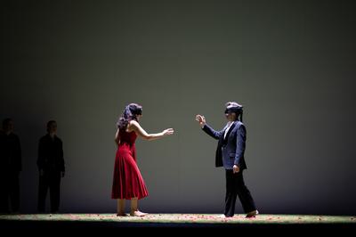 a man and women face each other blindfolded