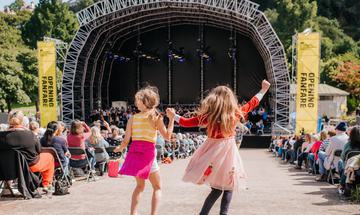 two girls dance holding hands
