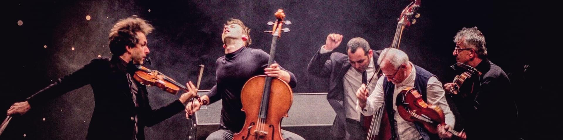 a group of five musicians have just finished playing and are posed dramatically