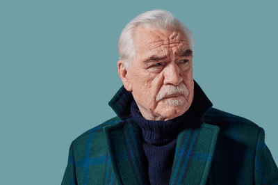 a man with grey hair looks to the right