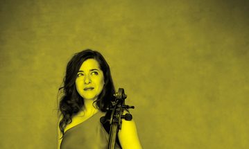 A black and yellow image of Alisa Weilerstein holding a cello and looking away from the camera