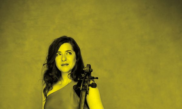 A black and yellow image of Alisa Weilerstein holding a cello and looking away from the camera