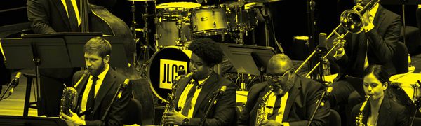 A black and yellow image of Jazz at Lincoln Center performing on stage