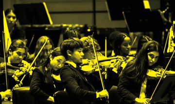 A black and yellow image of NYO USA performing on stage