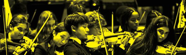 A black and yellow image of NYO USA performing on stage