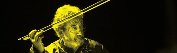 A black and yellow image of Jordi Savall holding a violin and pointing a bow in the air