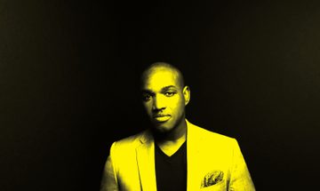 A black and yellow image of Lawrence Brownlee looking at the camera