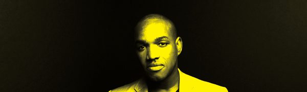 A black and yellow image of Lawrence Brownlee looking at the camera