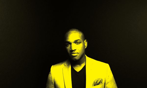 A black and yellow image of Lawrence Brownlee looking at the camera