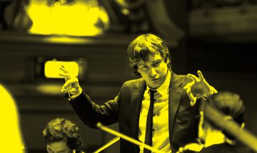 A black and yellow image of Maxim Emelyanychev conducting an orchestra