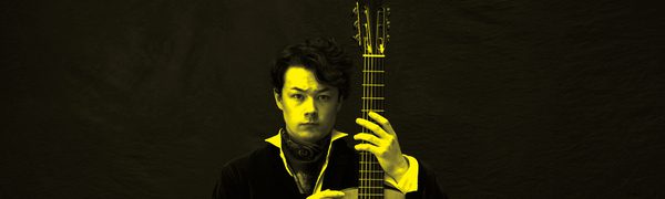 A black and yellow image of Sean Shibe holding a guitar and looking at the camera