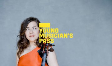 A yellow Young Musician's Pass logo in front of a woman wearing an orange dress resting her hands on a cello