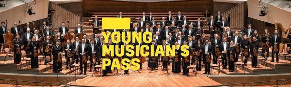A yellow Young Musicians Pass logo in front of the Berlin Philharmoniker standing on stage