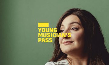 A yellow Young Musician's Pass logo in front of a woman wearing an off white dress smiling into the distance