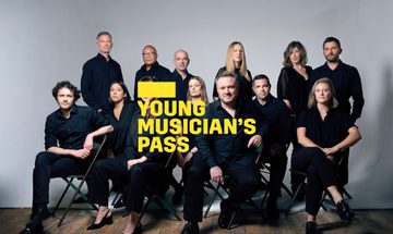 A yellow Young Musician's Pass logo in front of a group of musicians dressed in black