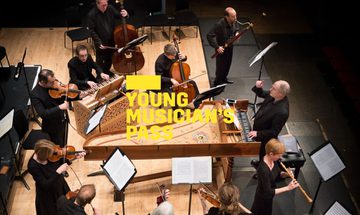 A yellow Young Musician's Pass logo in front of an image of an ensemble playing instruments from above