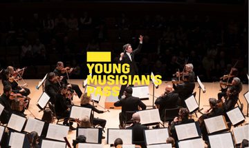 A yellow Young Musician's Pass logo in front of a conductor on stage facing the orchestra