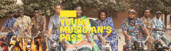 A yellow Young Musician's Pass logo in front of a group of people in colourful clothes sit on bikes smiling