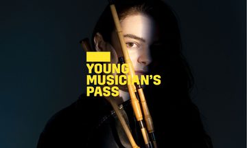 A yellow Young Musician's Pass logo in front of a woman mostly obscured by shadow holding a bagpipe instrument