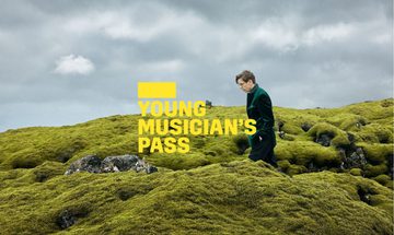 A yellow Young Musician's Pass logo in front of a man in a green jacket walking across a mossy hill