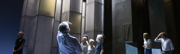 An image of people looking up at a stage set up