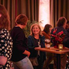 An image of people smiling and socialising