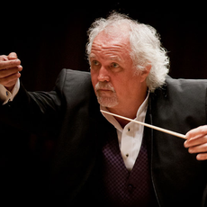 A conductor with white hair