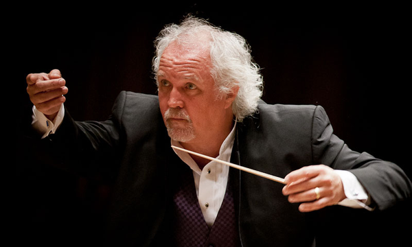 A conductor with white hair
