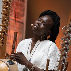 a women sings with her eyes closed