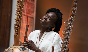 a women sings with her eyes closed