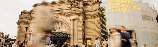 Exterior shot of Edinburgh’s Usher Hall, featuring crowd and EIF logo