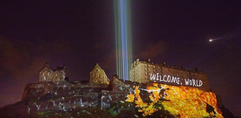 Projections on Edinburgh Castle with light beams going into the sky