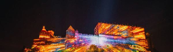 Projections on Edinburgh Castle with bright yellow and orange colours