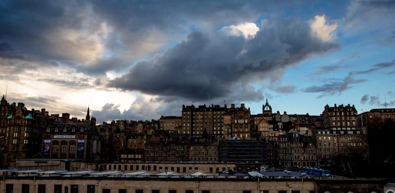 Edinburgh skyline against a blue sky with clouds