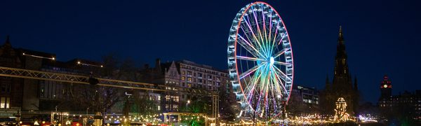 A ferris wheel is lit up against a dark night sky.