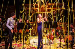 Yellow streamers descend from the ceiling on Nicola Benedetti and a group of musicians.